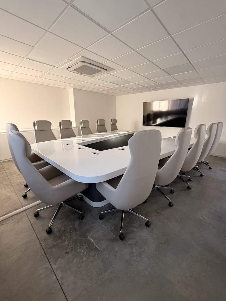 Sala riunioni Spaziozero con tavolo bianco e schermo